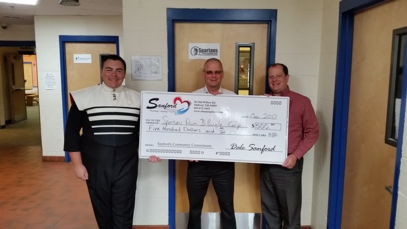 Sanford Temperature Control handing over a donation to Spartans Drum & Bugle Corp
