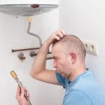 image a of a homeowner scratching his head puzzled by a boiler problem