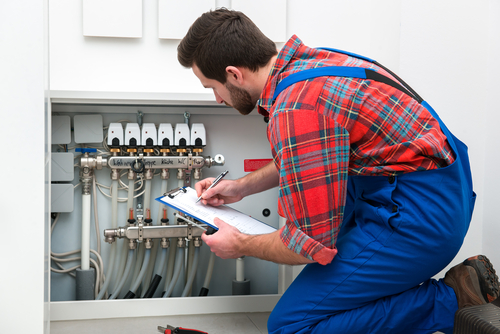 plumber fixing water heater