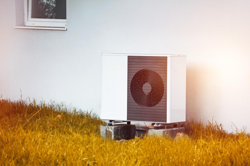 experts bringing in a heat pump inside a home