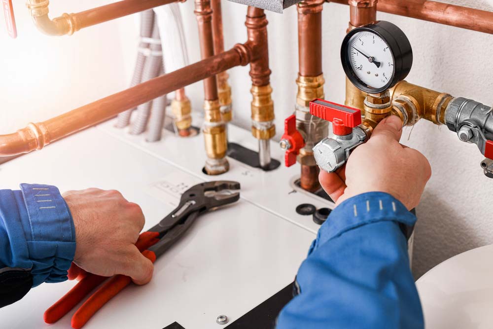 technician tinkering with a heating system